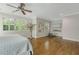 Airy bedroom featuring neutral walls, hardwood floors, white trim and sunny windows with white shutters at 1020 Austin Ne Ave, Atlanta, GA 30307