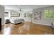 Spacious bedroom with hardwood floors, ceiling fan, neutral walls, and sunlit windows with white shutters at 1020 Austin Ne Ave, Atlanta, GA 30307