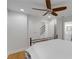 Bright bedroom with a ceiling fan, hardwood floors, and view to stairway and connecting bathroom at 1020 Austin Ne Ave, Atlanta, GA 30307