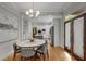 Dining area view to the kitchen and back door with hardwood floors and modern lighting at 1020 Austin Ne Ave, Atlanta, GA 30307