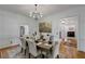 Formal dining room features wainscotting, hardwood floors and modern chandelier at 1020 Austin Ne Ave, Atlanta, GA 30307