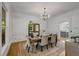 Dining room with wood floors and a view to the kitchen with stainless appliances and white cabinets at 1020 Austin Ne Ave, Atlanta, GA 30307
