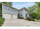 Stately home featuring two-car garage, screen porch, a lush yard and a long driveway at 1020 Austin Ne Ave, Atlanta, GA 30307