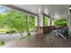 Inviting front porch with wood floors, brick accents and comfortable seating, offering a relaxing outdoor space at 1020 Austin Ne Ave, Atlanta, GA 30307