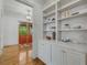 Stylish hallway featuring hardwood floors, built-in shelves, and elegant lighting, adding charm to the space at 1020 Austin Ne Ave, Atlanta, GA 30307