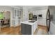 Well-lit kitchen with a gray kitchen island and white cabinets with stainless steel microwave and oven at 1020 Austin Ne Ave, Atlanta, GA 30307
