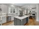 Bright, open kitchen with stainless steel appliances, an island cooktop, and views into the living area at 1020 Austin Ne Ave, Atlanta, GA 30307