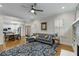 Living room featuring hardwood floors, a ceiling fan, large sofa, and a partial view to the kitchen at 1020 Austin Ne Ave, Atlanta, GA 30307