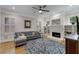 Cozy living room with white fireplace, a ceiling fan, and windows for natural light at 1020 Austin Ne Ave, Atlanta, GA 30307
