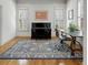 Bright home office features a black piano, stylish rug, and natural light from shuttered windows at 1020 Austin Ne Ave, Atlanta, GA 30307