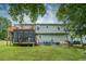 Spacious backyard featuring a screened-in porch, upper deck, and cozy seating area with charming string lights at 1565 Wynfield Dr, Auburn, GA 30011