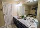 Bathroom featuring double sinks, a large mirror, and a soaking tub at 1565 Wynfield Dr, Auburn, GA 30011
