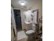 Cozy bathroom features a white vanity, toilet, tiled floors, and built-in storage at 1565 Wynfield Dr, Auburn, GA 30011