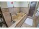 Luxurious bathroom showcasing a jetted tub and a separate glass-enclosed shower at 1565 Wynfield Dr, Auburn, GA 30011