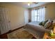 Comfortable bedroom features a ceiling fan and a window for natural light at 1565 Wynfield Dr, Auburn, GA 30011
