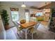 Inviting kitchen area with a wooden dining table and chairs, complemented by modern appliances and ample natural light at 1565 Wynfield Dr, Auburn, GA 30011