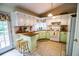 Charming kitchen with white cabinets, wooden countertops, and a view to the deck at 1565 Wynfield Dr, Auburn, GA 30011