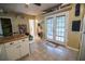 Bright kitchen with white cabinets, tile floors, and access to the outdoor patio at 1565 Wynfield Dr, Auburn, GA 30011