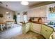 Charming kitchen with an adjacent dining area, light green cabinets, and wood countertops at 1565 Wynfield Dr, Auburn, GA 30011