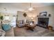Inviting living area with a fireplace, comfortable seating, and natural light from a nearby dining area at 1565 Wynfield Dr, Auburn, GA 30011