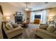 Cozy living room with a fireplace, comfortable seating, and a large bay window offering plenty of natural light at 1565 Wynfield Dr, Auburn, GA 30011