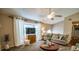 Bright living room with a ceiling fan, large windows, and neutral decor at 1565 Wynfield Dr, Auburn, GA 30011