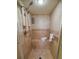 Tiled shower stall offers a built-in bench, handheld sprayer, and grab bar for safety at 1565 Wynfield Dr, Auburn, GA 30011