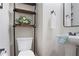 Charming half-bathroom featuring a decorative shelf, modern sink, mirror, and towel rack at 161 Overlook Cir, Canton, GA 30115