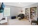 Comfortable bedroom with large window, bookcases and relaxing sitting area at 161 Overlook Cir, Canton, GA 30115