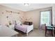 bedroom featuring a twin bed, desk, dresser, and wall decorations at 161 Overlook Cir, Canton, GA 30115