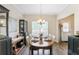 Charming dining room with a wooden table, elegant lighting, and tasteful decor and window with natural light at 161 Overlook Cir, Canton, GA 30115