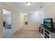 Well-lit upstairs hallway featuring neutral paint, carpet flooring, and doors leading to the bedrooms at 161 Overlook Cir, Canton, GA 30115