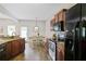 Modern kitchen with granite countertops, stainless steel appliances, and an adjacent dining area with a door to the yard at 161 Overlook Cir, Canton, GA 30115