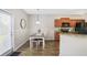 Kitchen with an adjacent dining nook, featuring wooden cabinets, modern appliances, and wood-look flooring at 161 Overlook Cir, Canton, GA 30115