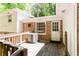 Exterior shot of a back porch with weathered wooden planks and a brick wall at 2620 Clairmont Rd, Atlanta, GA 30329