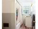 Modest bathroom with shower and tub, tile floors and a window at 2620 Clairmont Rd, Atlanta, GA 30329