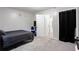 Spacious bedroom featuring simple sun and moon decor, a sleek fan, and a roomy closet at 2620 Clairmont Rd, Atlanta, GA 30329