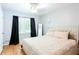 Calm bedroom with a plush bed, dark curtains, wood flooring and ample natural light at 2620 Clairmont Rd, Atlanta, GA 30329