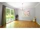 The dining room has hardwood floors, large windows looking out to the lush yard, and modern light fixtures at 2620 Clairmont Rd, Atlanta, GA 30329