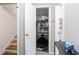 Functional laundry area with front loading washer and convenient storage shelving and staircase at 2620 Clairmont Rd, Atlanta, GA 30329