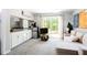 Open-concept living space with a kitchenette, comfortable seating, and sliding glass doors to the outside at 2620 Clairmont Rd, Atlanta, GA 30329
