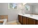 Bathroom featuring double sinks, wood cabinets, a soaking tub, and natural light at 3066 Quantum Ln # 24, Atlanta, GA 30341