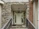 Townhome entrance detailed with stone, brick, and a traditional white door with glass accents at 3066 Quantum Ln # 24, Atlanta, GA 30341
