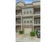 Townhome exterior with garages and private balconies, enhanced by manicured landscaping and parking at 3066 Quantum Ln # 24, Atlanta, GA 30341