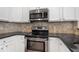 Close-up of stainless steel oven and granite counter top at 3066 Quantum Ln # 24, Atlanta, GA 30341