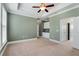 Spacious main bedroom features a tray ceiling, modern ceiling fan, and neutral decor at 3066 Quantum Ln # 24, Atlanta, GA 30341
