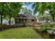 A spacious backyard featuring a screened-in porch, wooden deck, mature trees, and a well-maintained lawn at 978 Eden Se Ave, Atlanta, GA 30316