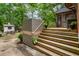Multi-level wooden deck and steps leading to a patio area with lush backyard and shed at 978 Eden Se Ave, Atlanta, GA 30316
