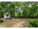 Concrete patio area featuring a shed, wooden fence, mature trees and manicured landscaping at 978 Eden Se Ave, Atlanta, GA 30316