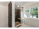 Bright bathroom featuring tiled floors, a tiled shower, and a large window at 978 Eden Se Ave, Atlanta, GA 30316